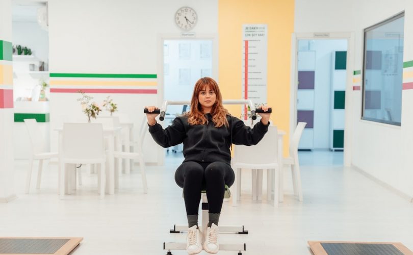 a woman sitting on top of a machine in a room